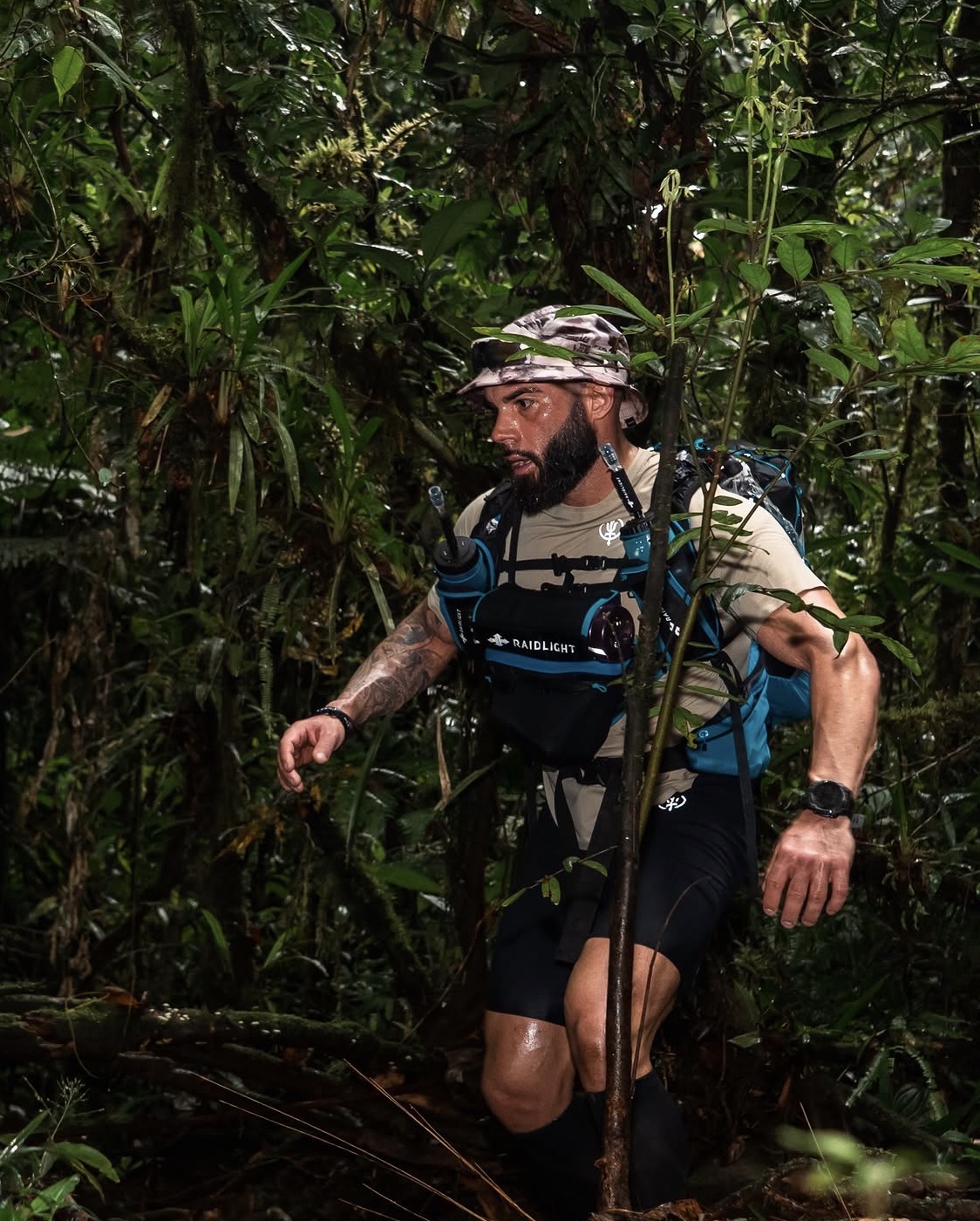 Stephen during the Amazon Jungle Ultra — river crossing, jungle canopy, ThruDark kit visible.